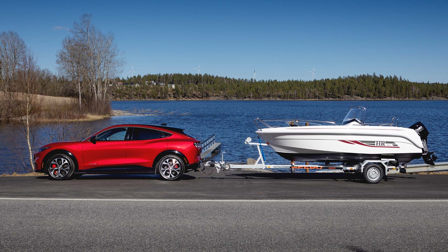 Red Mustang Mach-E with boat