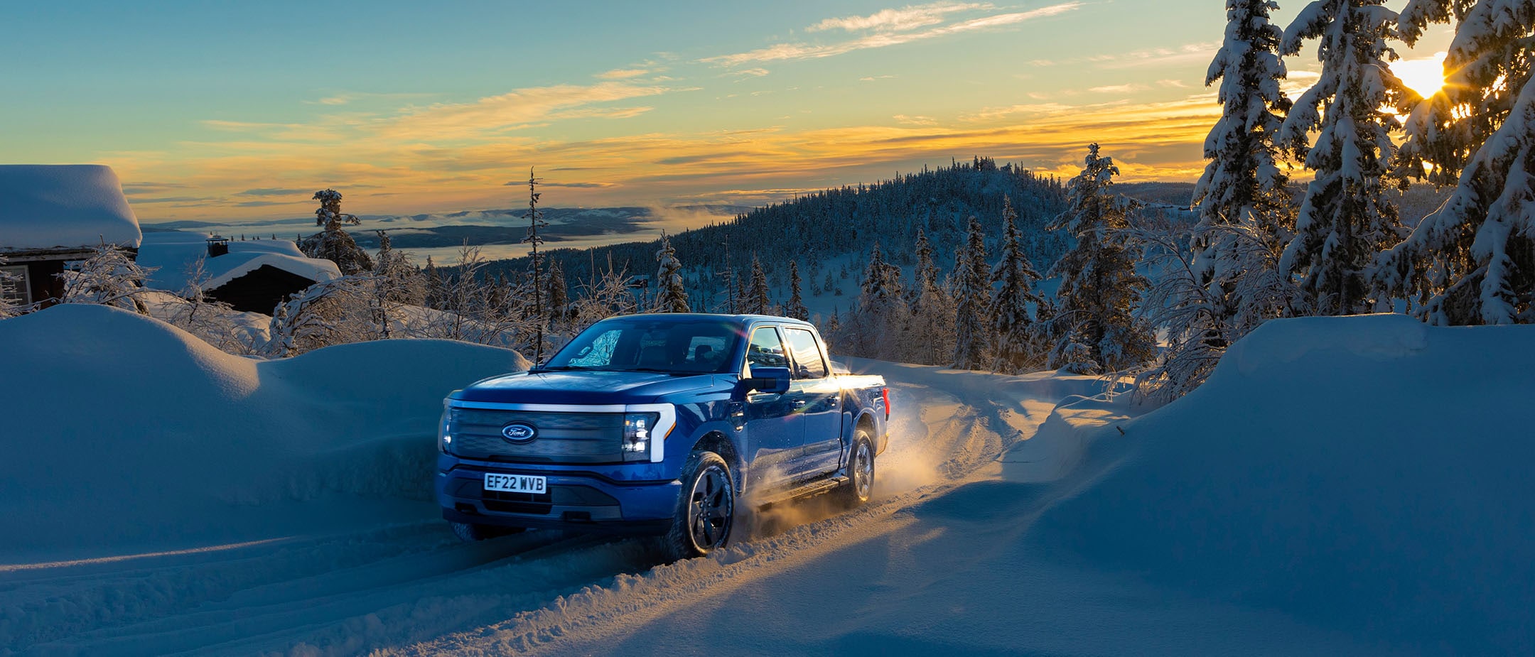 Ford F-150 Lightning driving through the snow