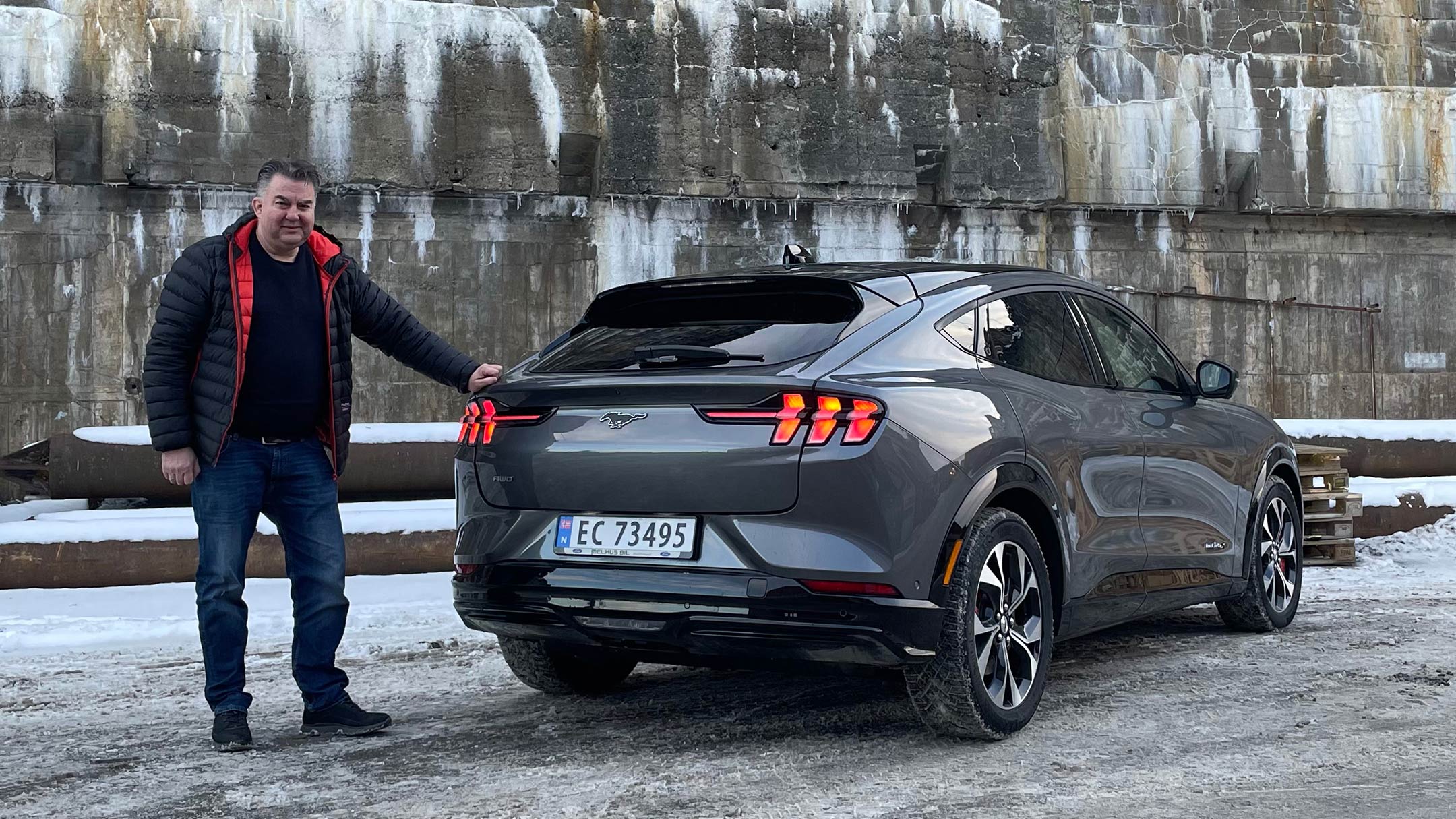 Man standing next to Mustang Mach-E