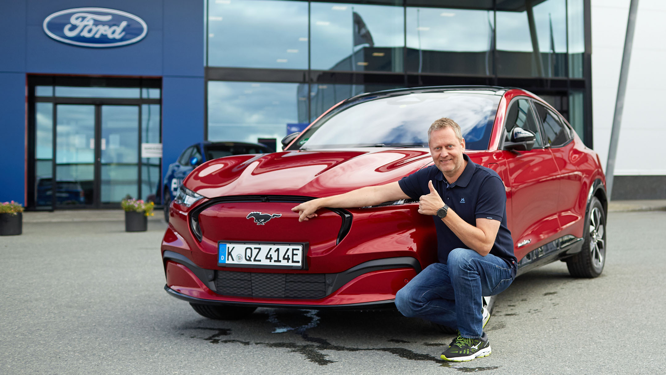 Red Mustang Mach-E with man