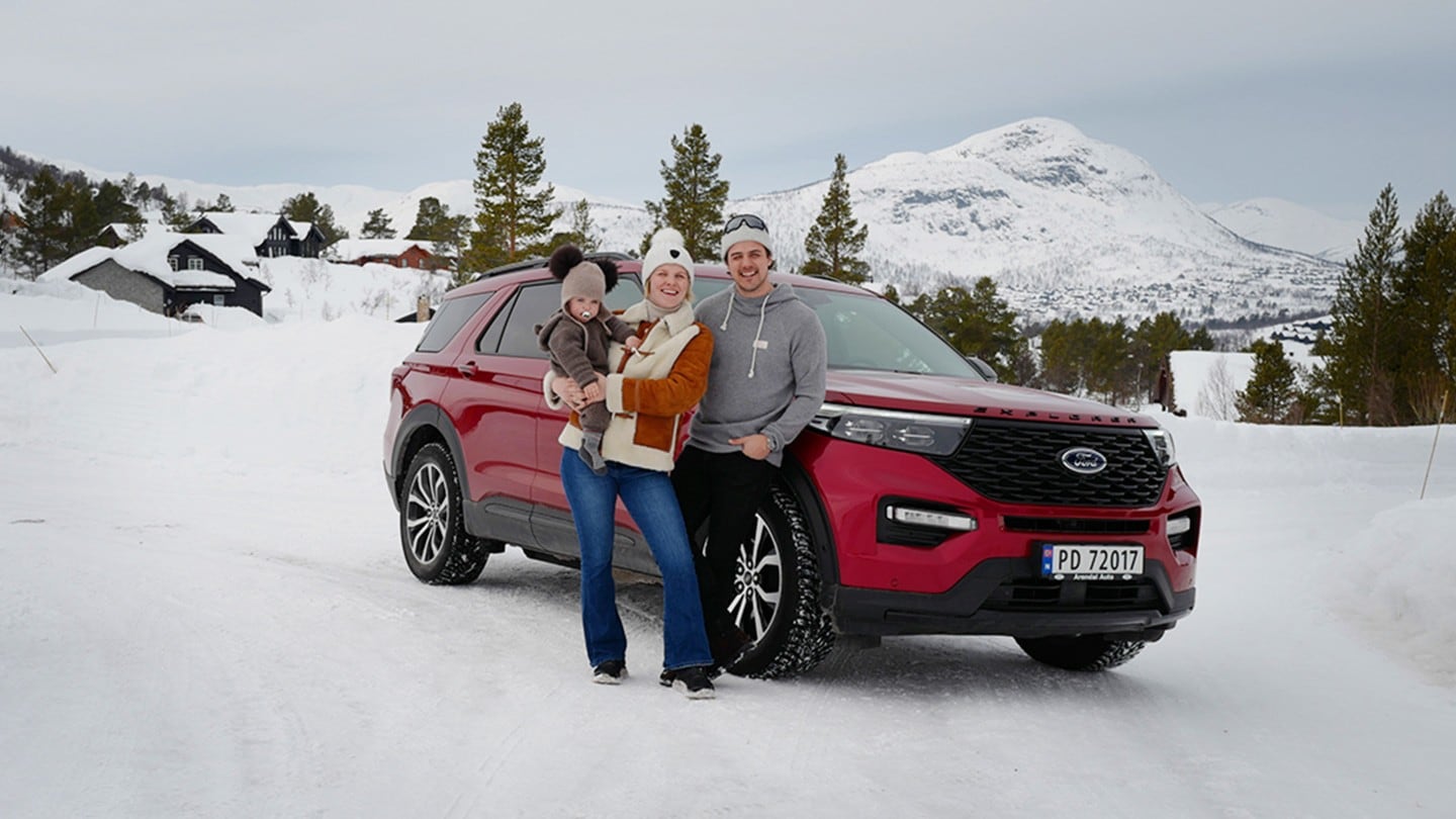 Family standing next to Explorer