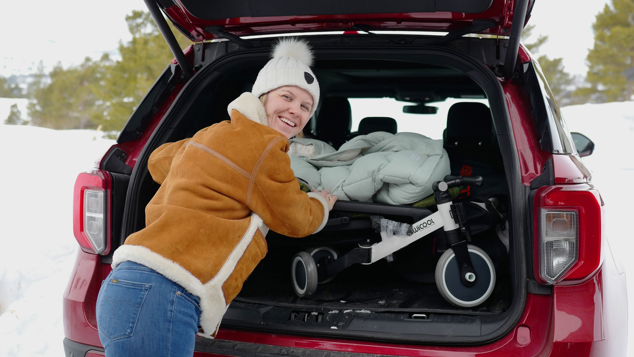 Woman smiling outside a car