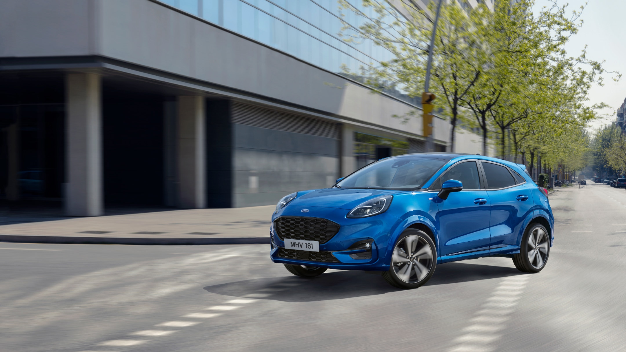 Ford Puma on the road near modern building