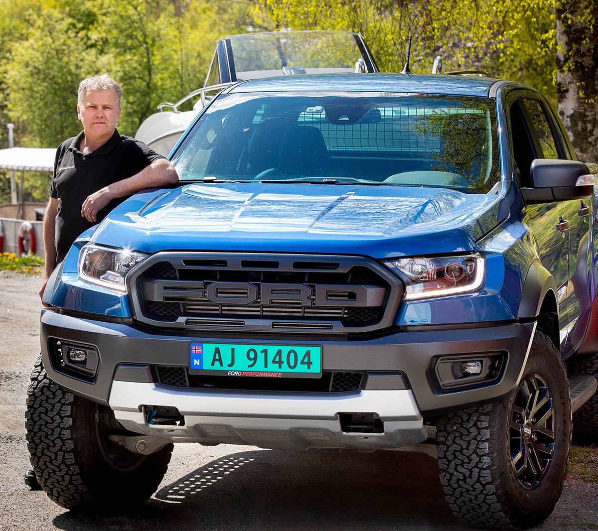 Ford Ranger Raptor in Blue with a man standing by