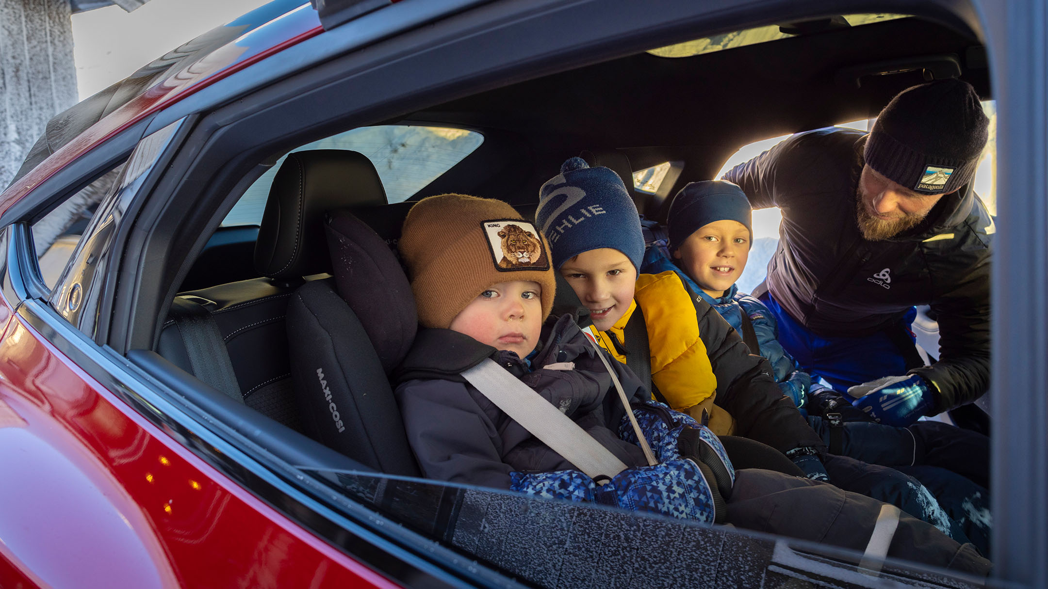 Kids sitting in backseat of Mustang Mach-E