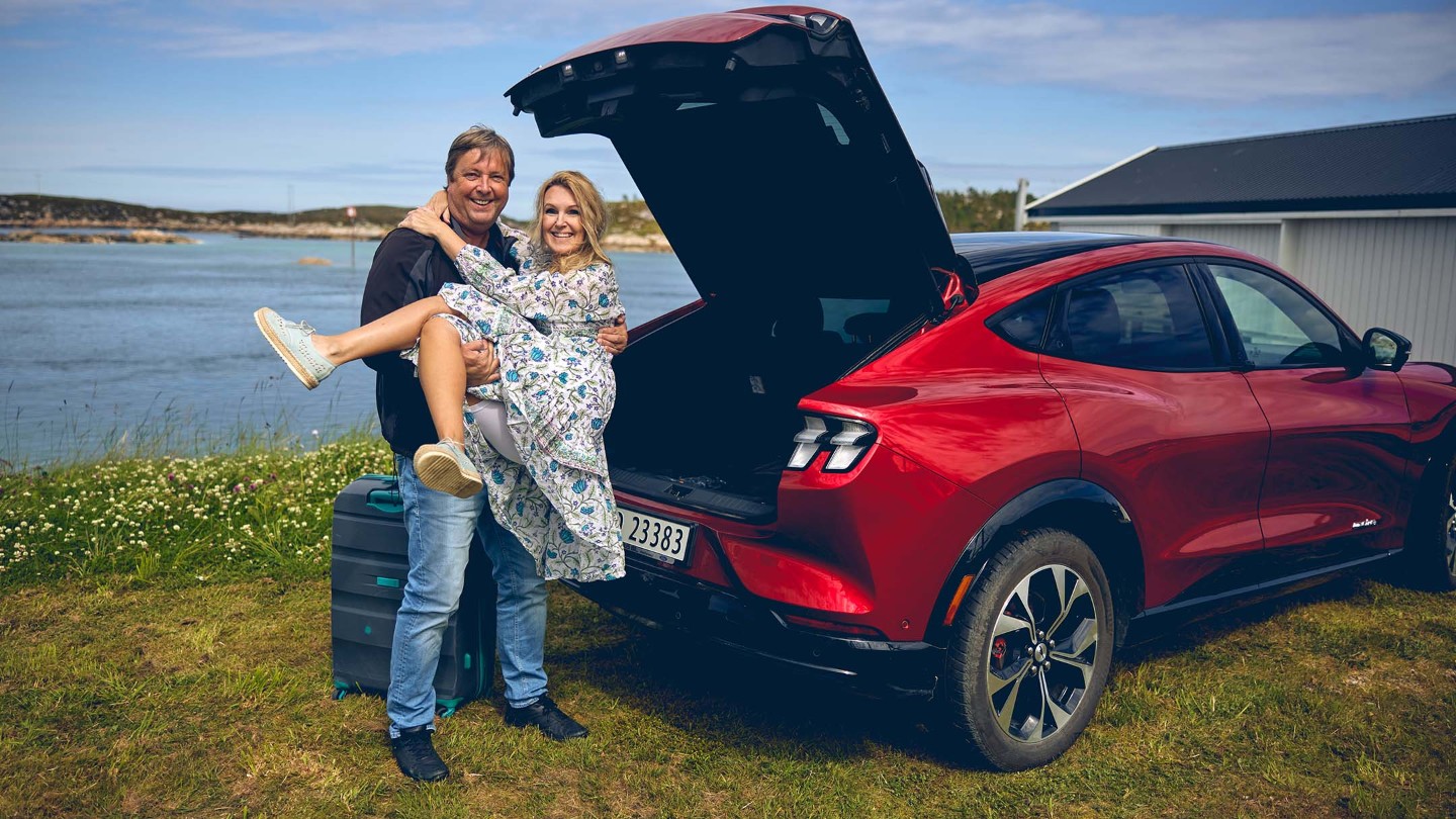 Happy couple next to the Mustang Mach-E