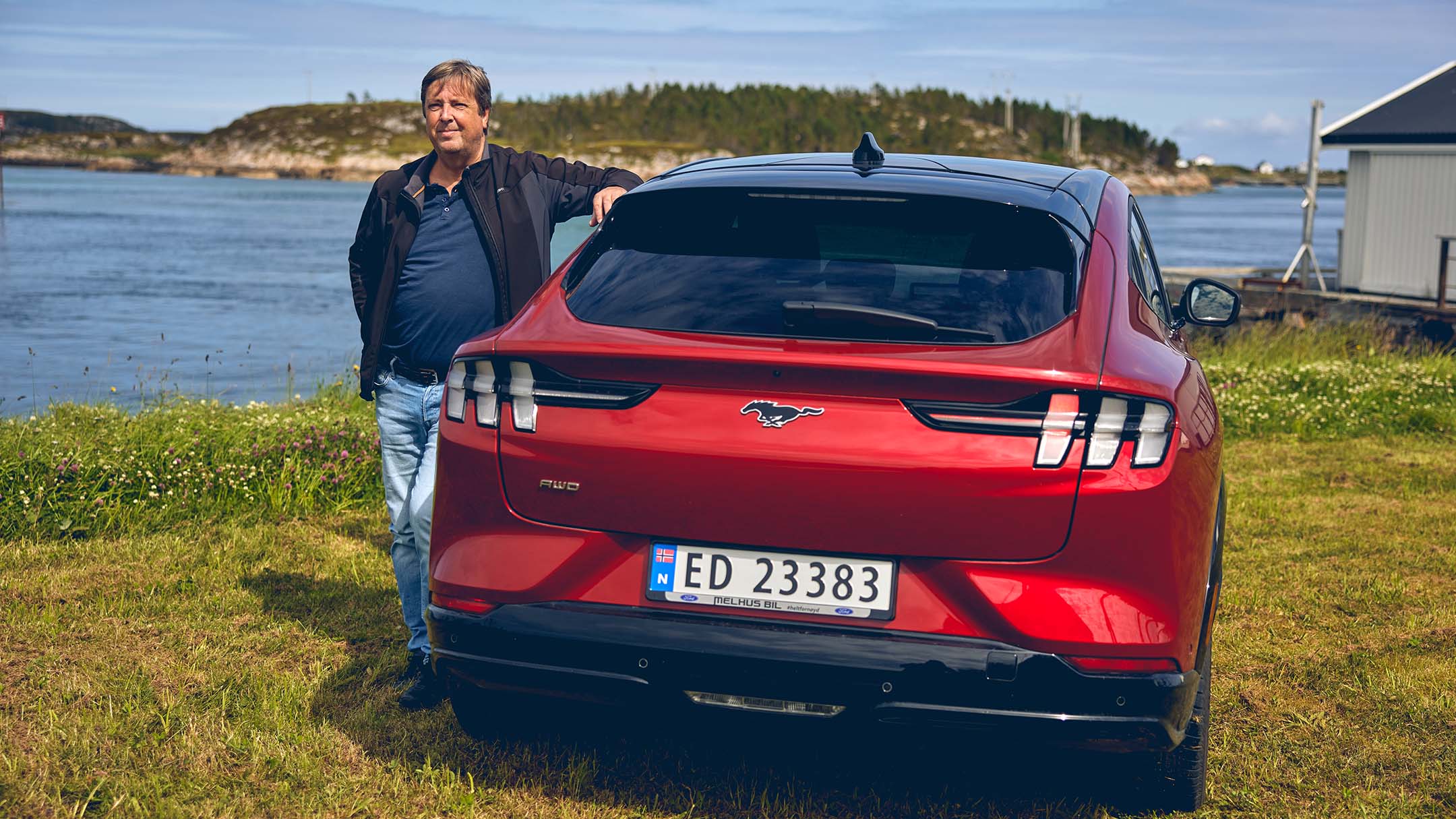 Man standing next to the Mustang Mach-E