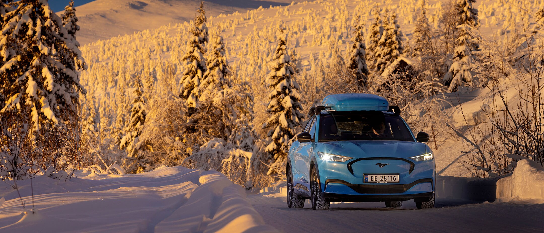 A blue Mustang Mach-E in the snow