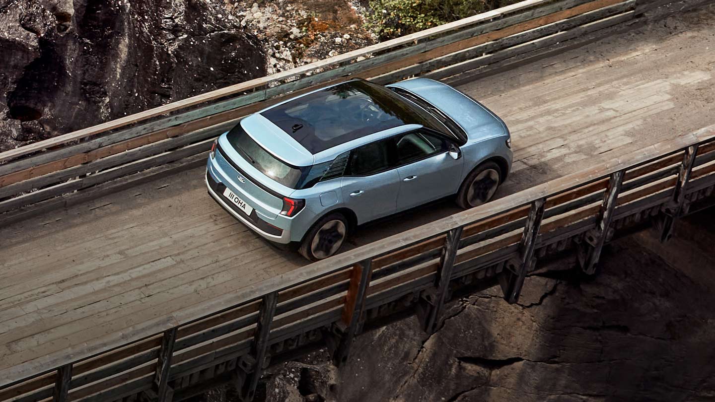 New Ford Explorer driving over a bridge in the wild