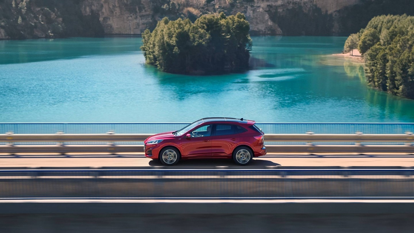 Ford Kuga PHEV driving across a bridge