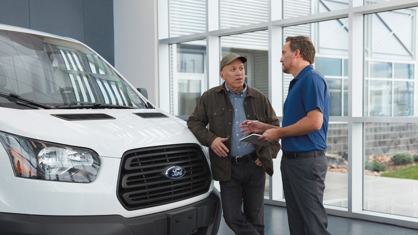 A Ford employee communicates with a client