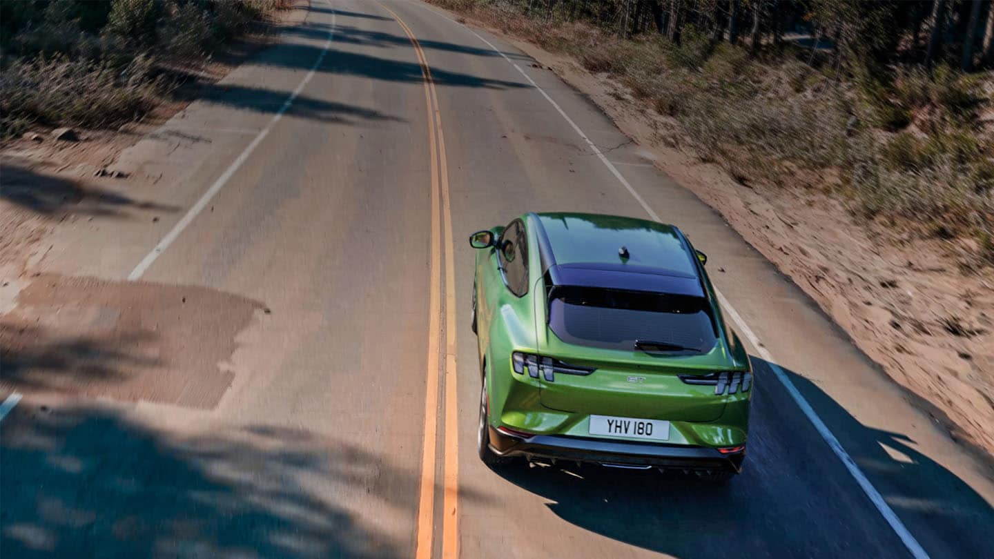 Green Ford Mustang Mach-E GT on the road.