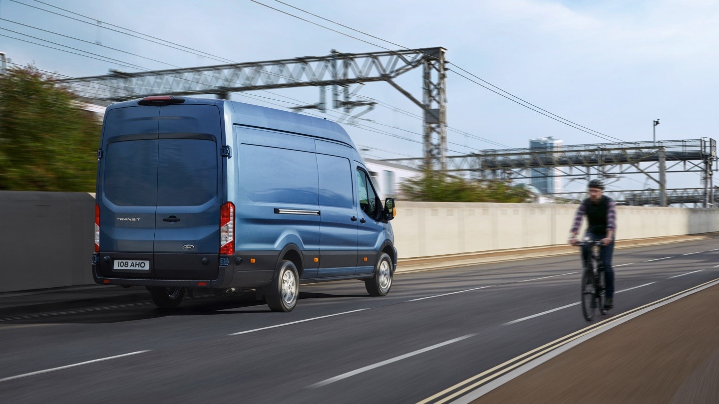 Blue Transit Van rear view driving on road