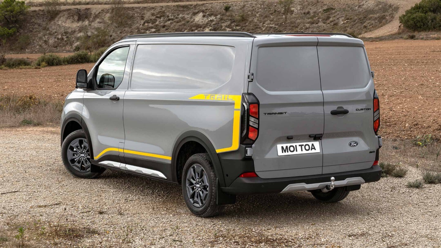 Ford Transit Trail parked on gravel road