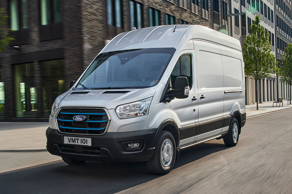 Ford E-Transit Van driving along street.