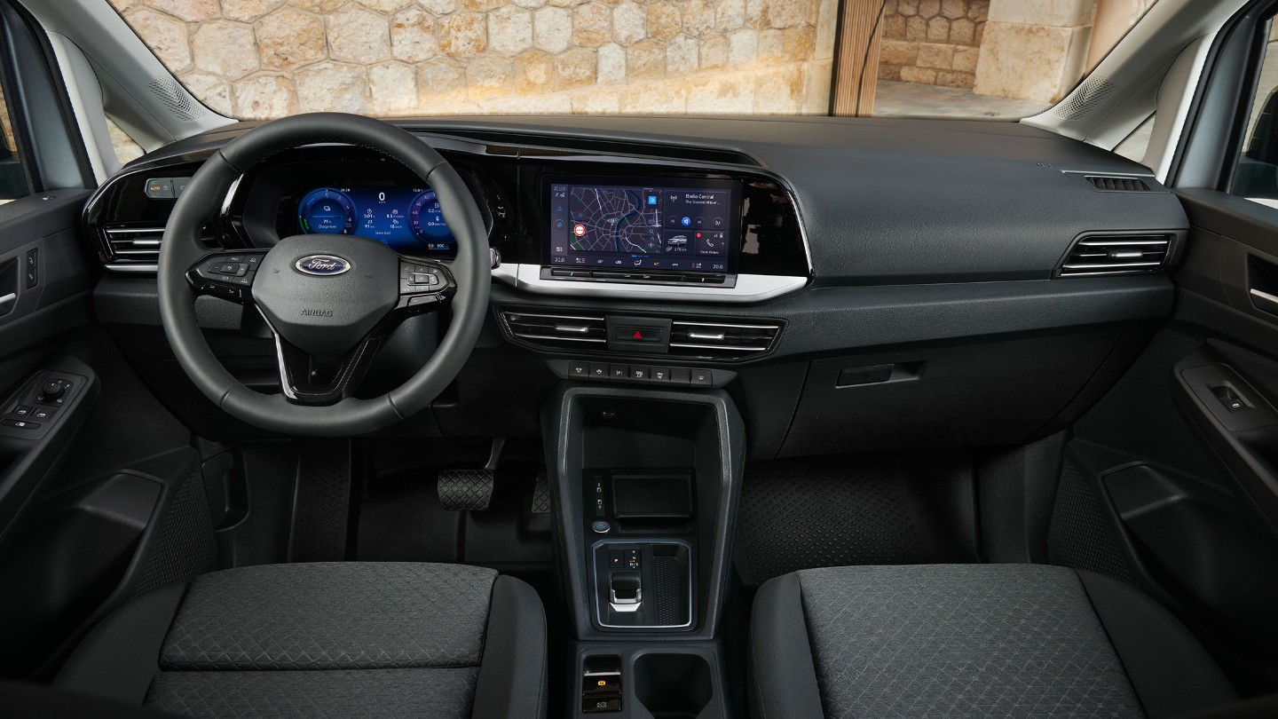 Interiøret foran i splitter nye Ford Transit Connect som viser rattet, det digitale clusteret og touchskjermen på 10 tommer. 
