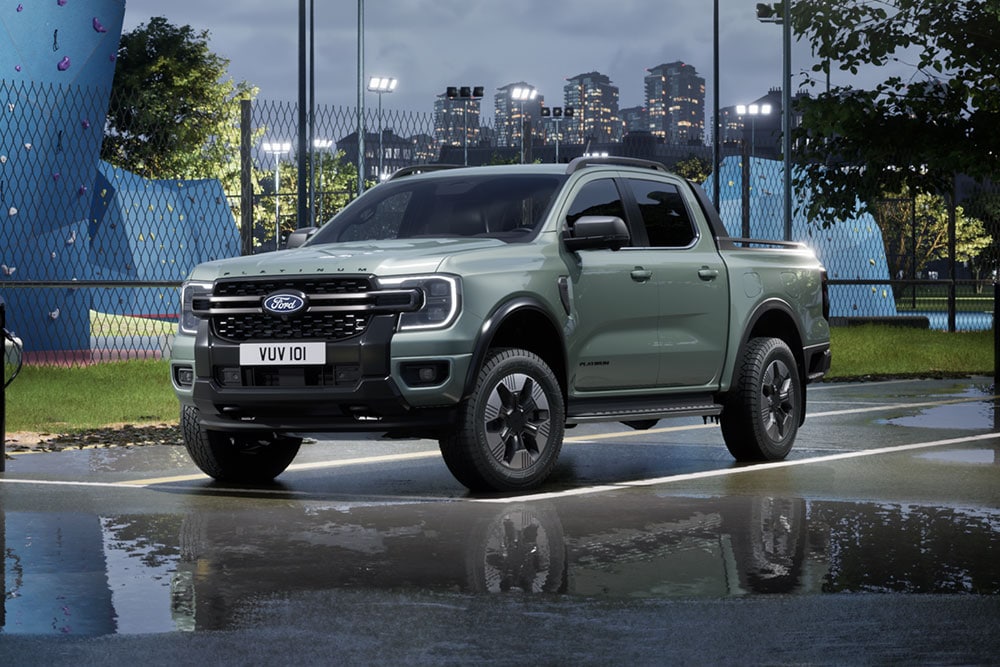 Grey Ford Ranger PHEV parkert foran et urbant bybilde i skumringen.