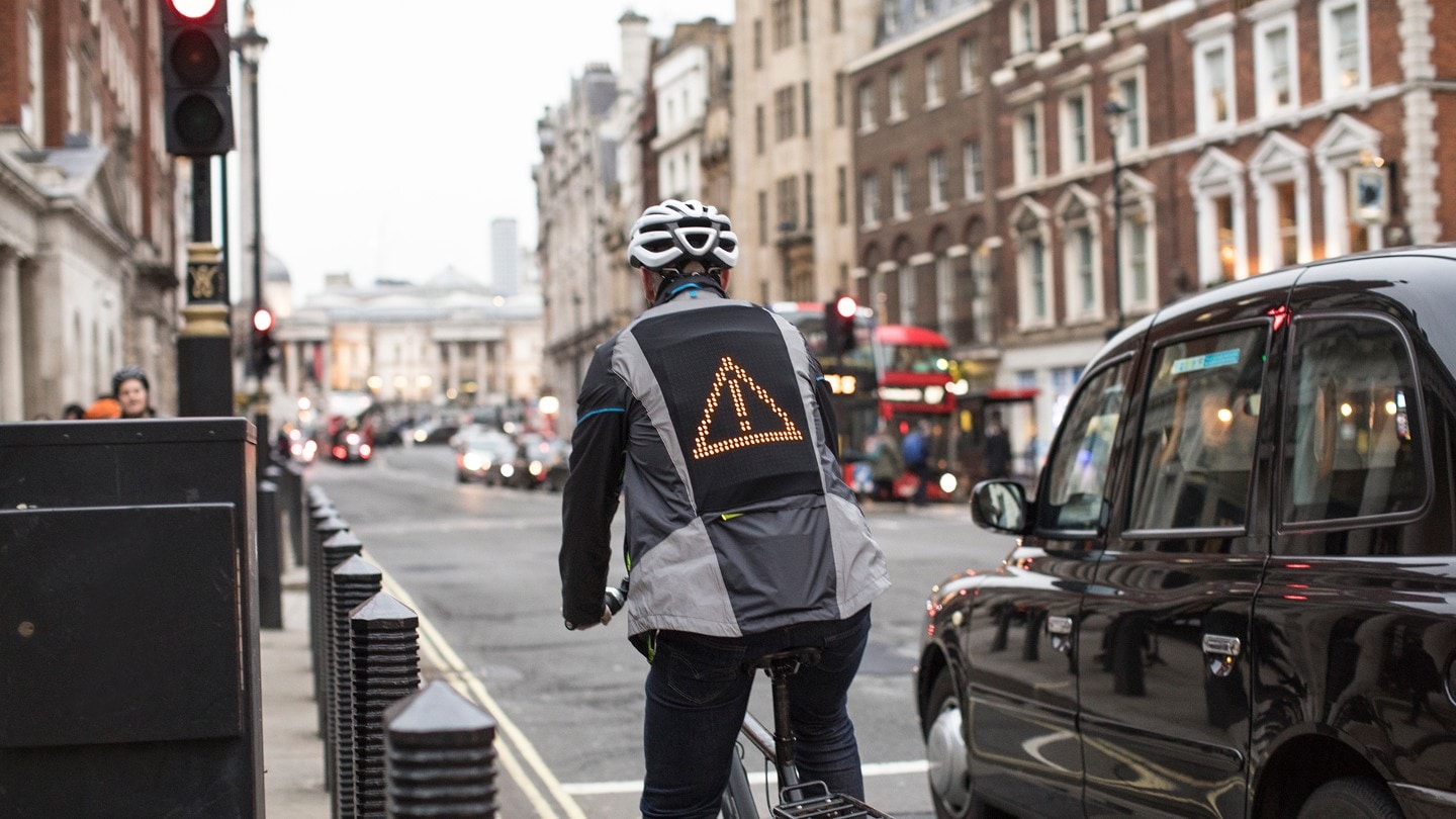 Cyclist wearing Ford emoji jacket