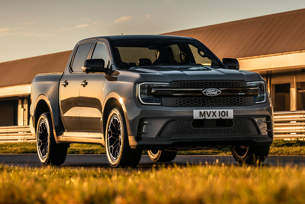 Sølvfarget Ford Pro Ranger Plug-in Hybrid parkert foran en industribygning.
