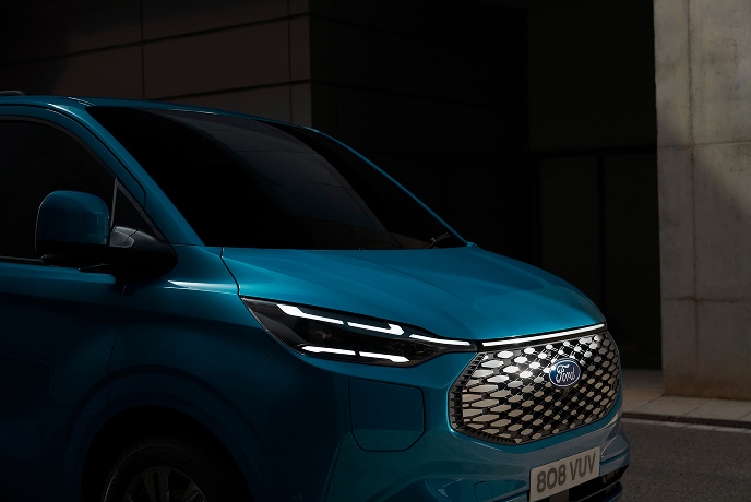 Nærbilde av en blå elektrisk Ford E-Transit Custom varebil.