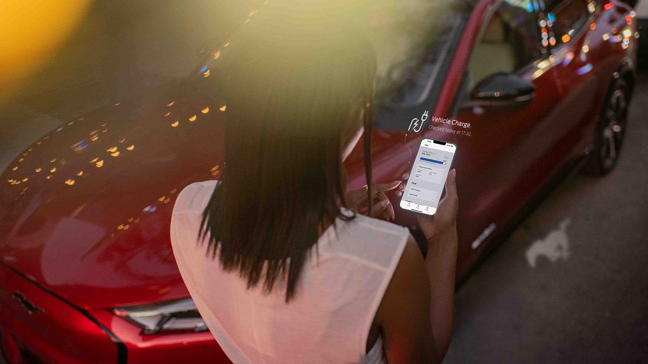Man looking at smartphone with Ford app displayed