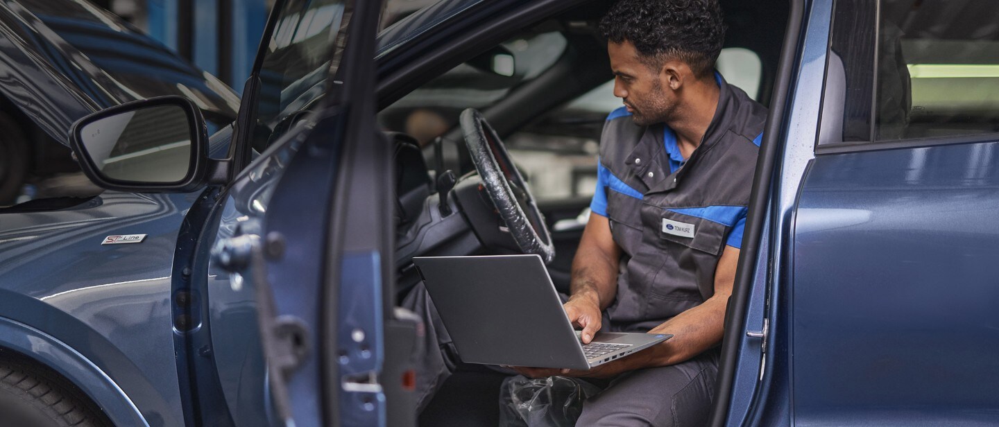 Ford service repair engineers, conducting an engine check