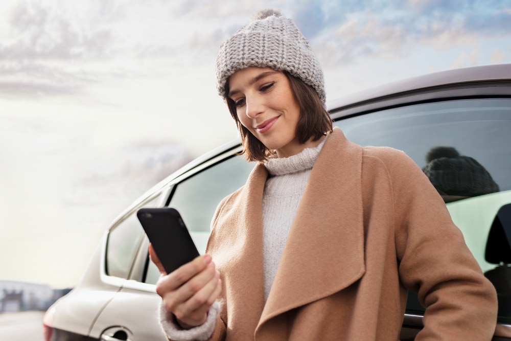  Smiling woman looking at her smartphone